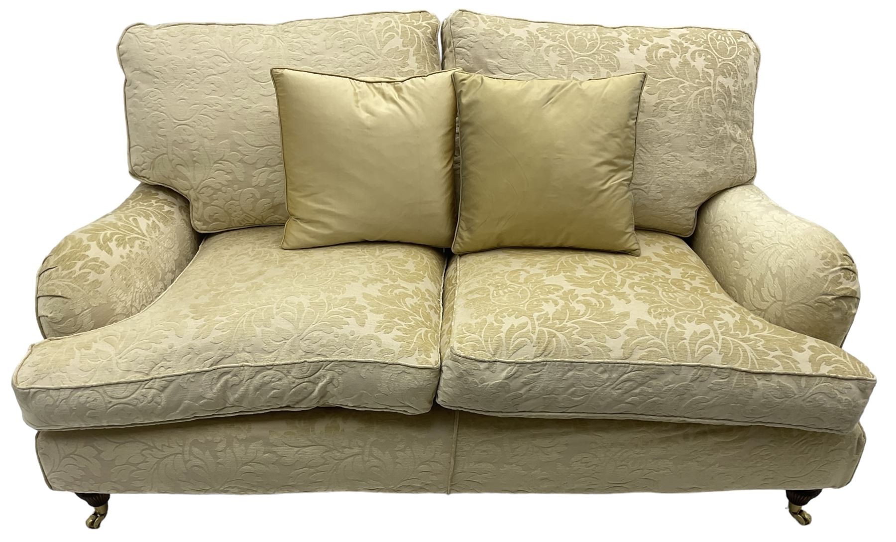 Multi-York - Howard shape two-seat sofa, upholstered in scrolling floral pattern loose covers, rolled arms, on turned front feet with brass cups and castors