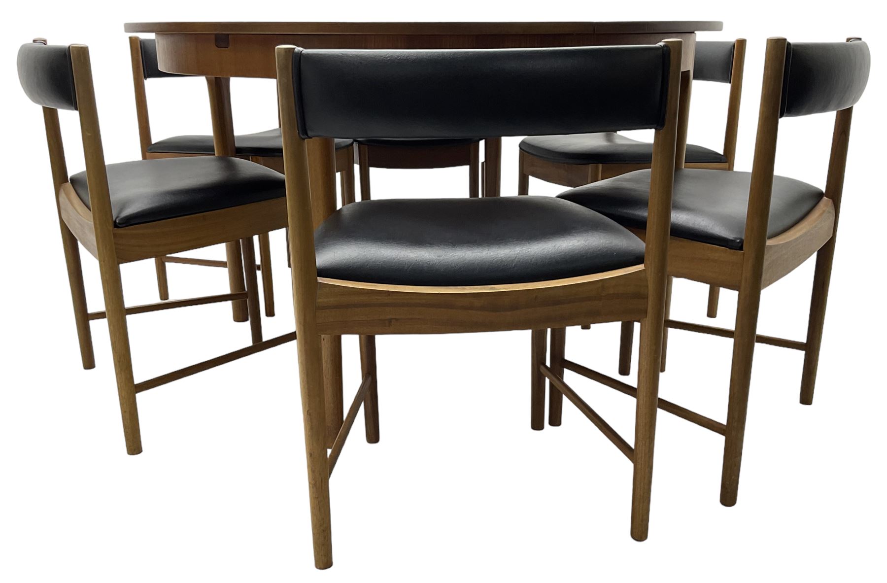 AH McIntosh & Co of Kirkaldy - mid-20th century teak extending dining table, circular top, concealed integrated double leaf, raised on tapered supports, label plaque to underside of leaf, together with a set of six chairs upholstered in black leatherette