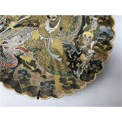 Japanese Meiji period Satsuma dish, of circular form with lobed edge, decorated with warrior slaying dragon and other figures, with character mark encased in fan beneath, D20cm