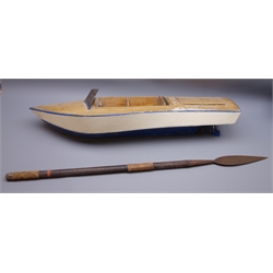  Battery powered model speedboat with blue and white painted wooden hull, simulated planked deck, two rows of seating with fitted ship's wheel and windscreen L92cm together with a native style ceremonial spear (2)  