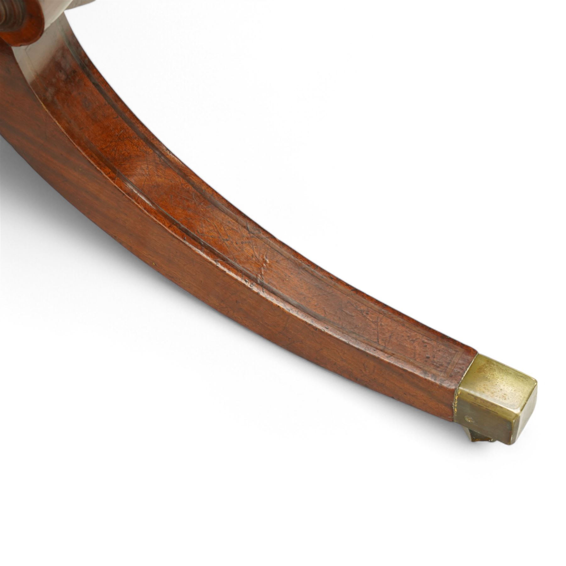 Regency figured mahogany breakfast table, figured rectangular tilt-top with rounded corners and rosewood banding, on turned column with four out-splayed supports with brass cups and castors 