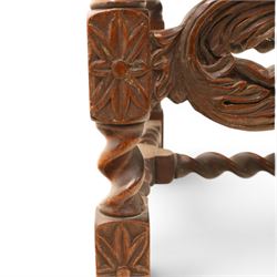 Late Victorian Jacobean Revival oak armchair, the caned back within a pierced and carved foliate frame surmounted by acorn finials, carved scroll arm supports, caned seat, on barley twist supports united by stretchers and carved front rail