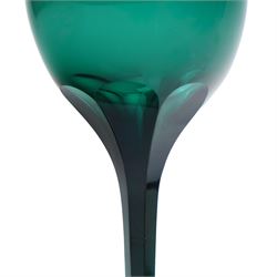 Five green wine glasses of early 19th century design with conical bowls and double knop stems on a circular foot, with pontil marks, pair of green wine glasses with chamfered stems together with an Asprey catalogue of green glass 1740-1840 and two pieces of glass fruit and leaves