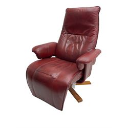 Swivel and adjustable armchair upholstered in red leather