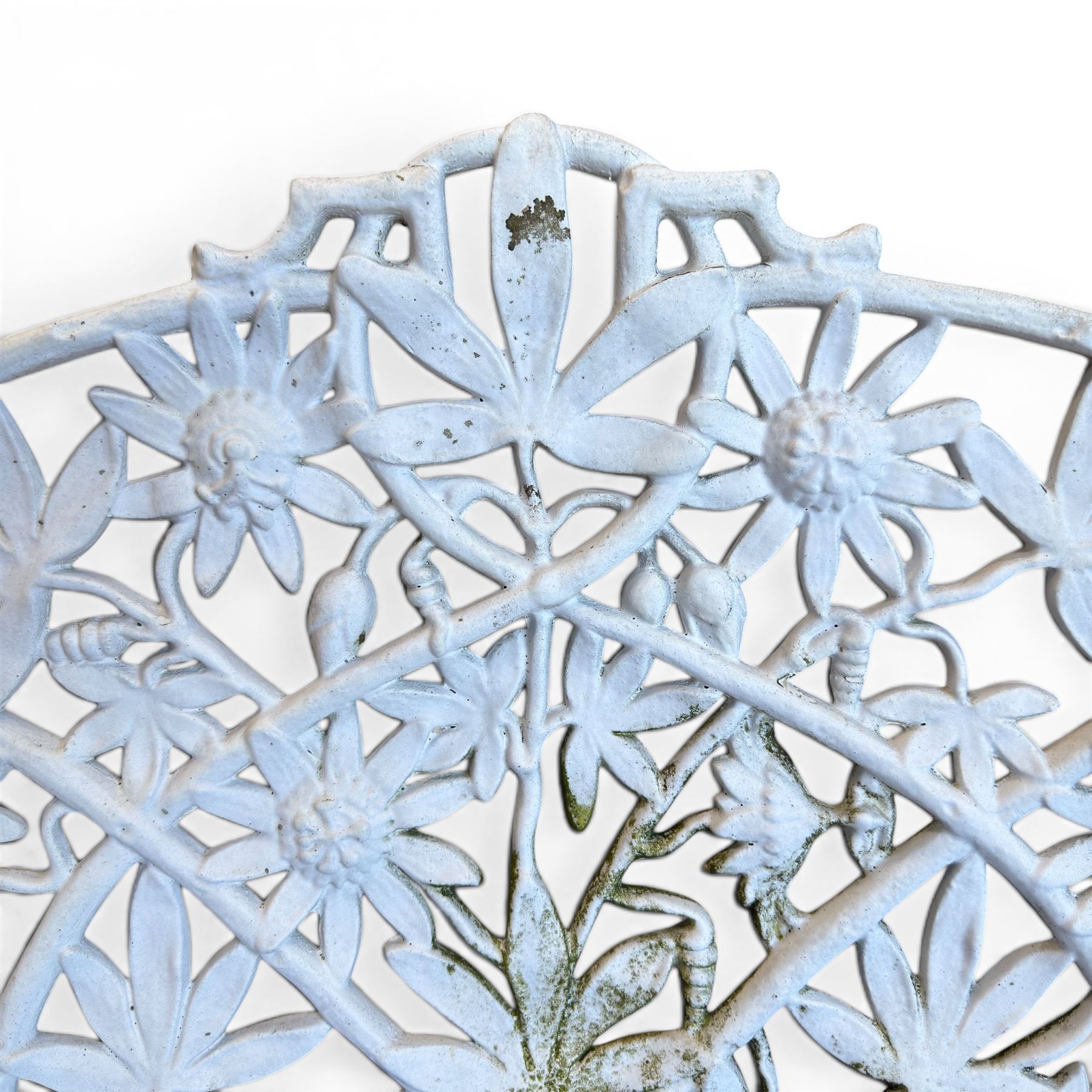 Victorian revival cast two seat garden bench, scrolling lattice back with flower heads, terminating to rams heads arms, curved pierced seat, finished in antique white paint