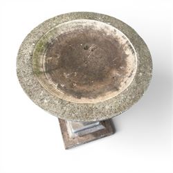 Weathered cast stone statue of a child and urn planter on pedestal along with three piece bird bath