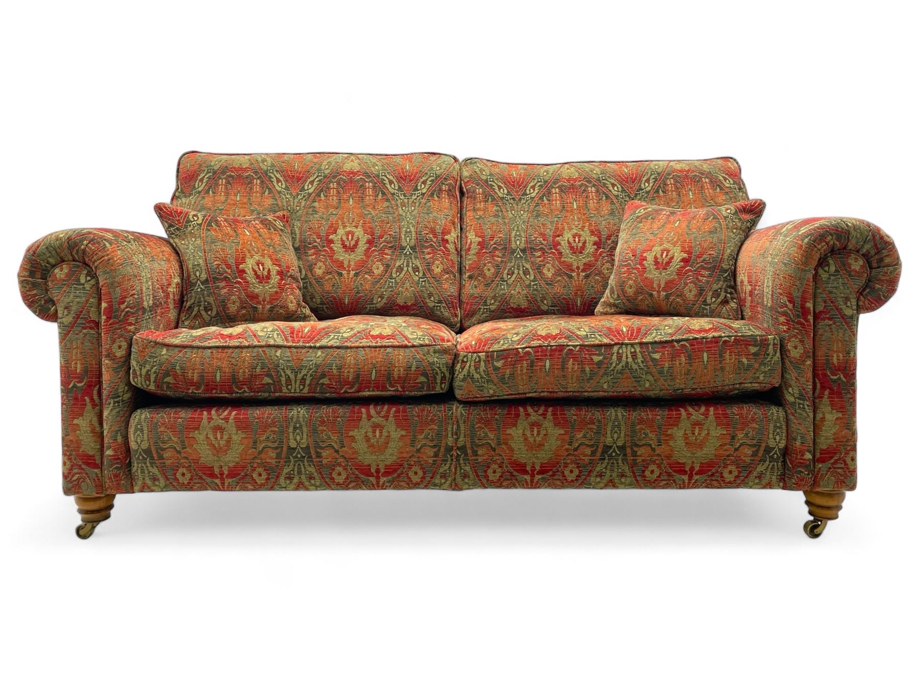 Duresta - 'Beaminster' grande two-seat sofa, traditional shape with rolled arms, upholstered in 'Althorp' russet and stone floral pattern fabric, on turned feet with brass castors

