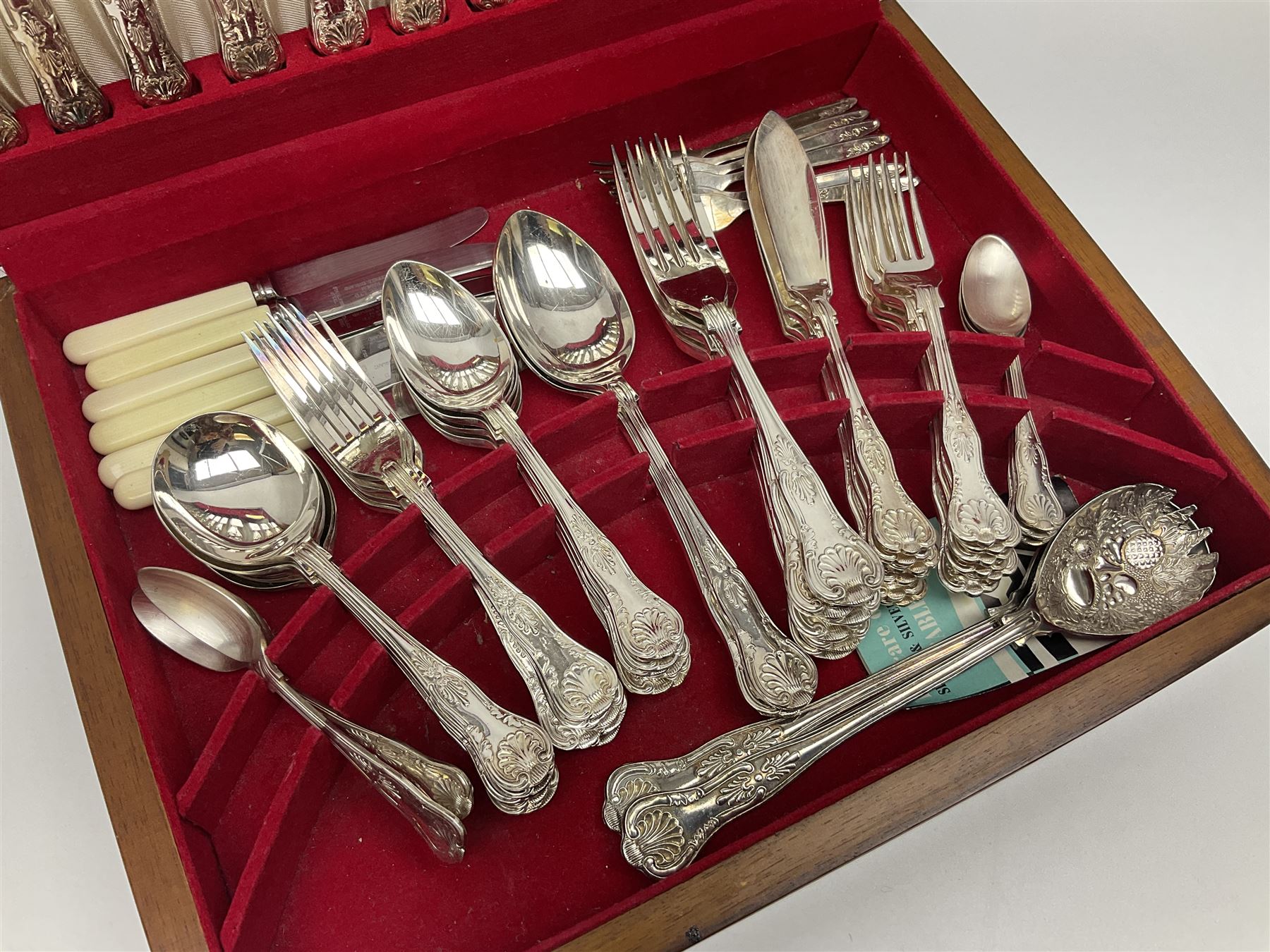 Canteen of King's pattern cutlery for six place settings by James Ryals of Sheffield, with two extra forks, pair of salad servers and six fish knives, all within fitted wooden case, together with six ivorine handled butter knives and six silver plated cake forks