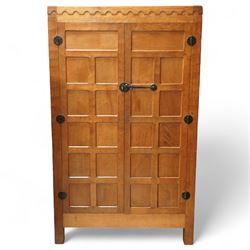 Mouseman - Oak 5' x 3' wardrobe, circa 1950s, scalloped cornice, panelled sides and front, twin doors with wrought metal latch and hinges, raised on stile supports with carved mouse to left hand side, by the workshop of Robert Thompson, Kilburn

Provenance - this lot comes to us for sale from direct descent of Robert Thompson. Thompson is the great grandfather of the vendor.
