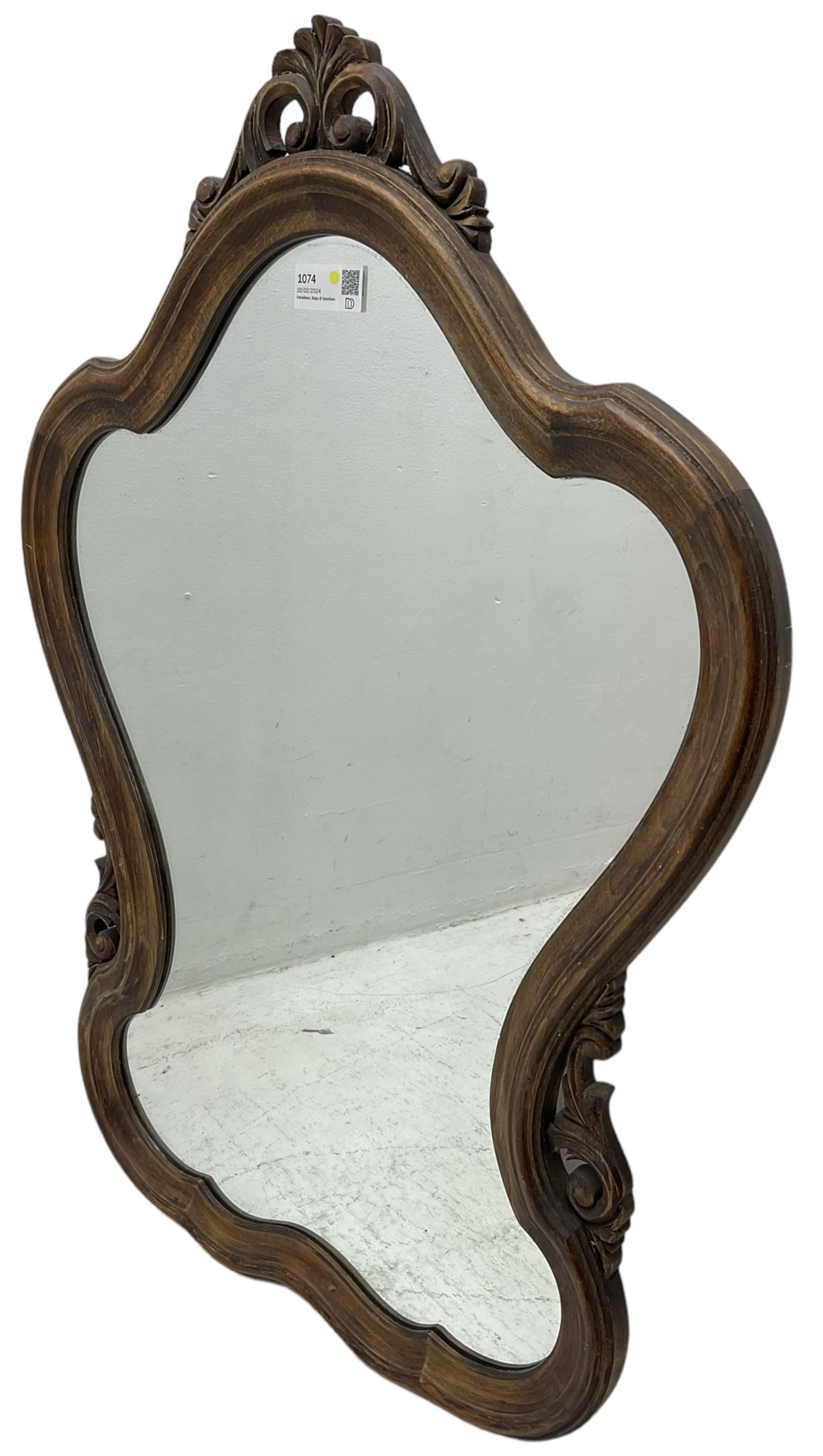 French design stained beech framed wall mirror, shaped and moulded framed with scrolling foliage carved pediment and brackets, plain mirror plate 
