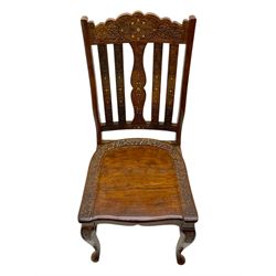 Pakistan carved hardwood brass inlaid circular dining table, and four rail back chairs with saddle seats