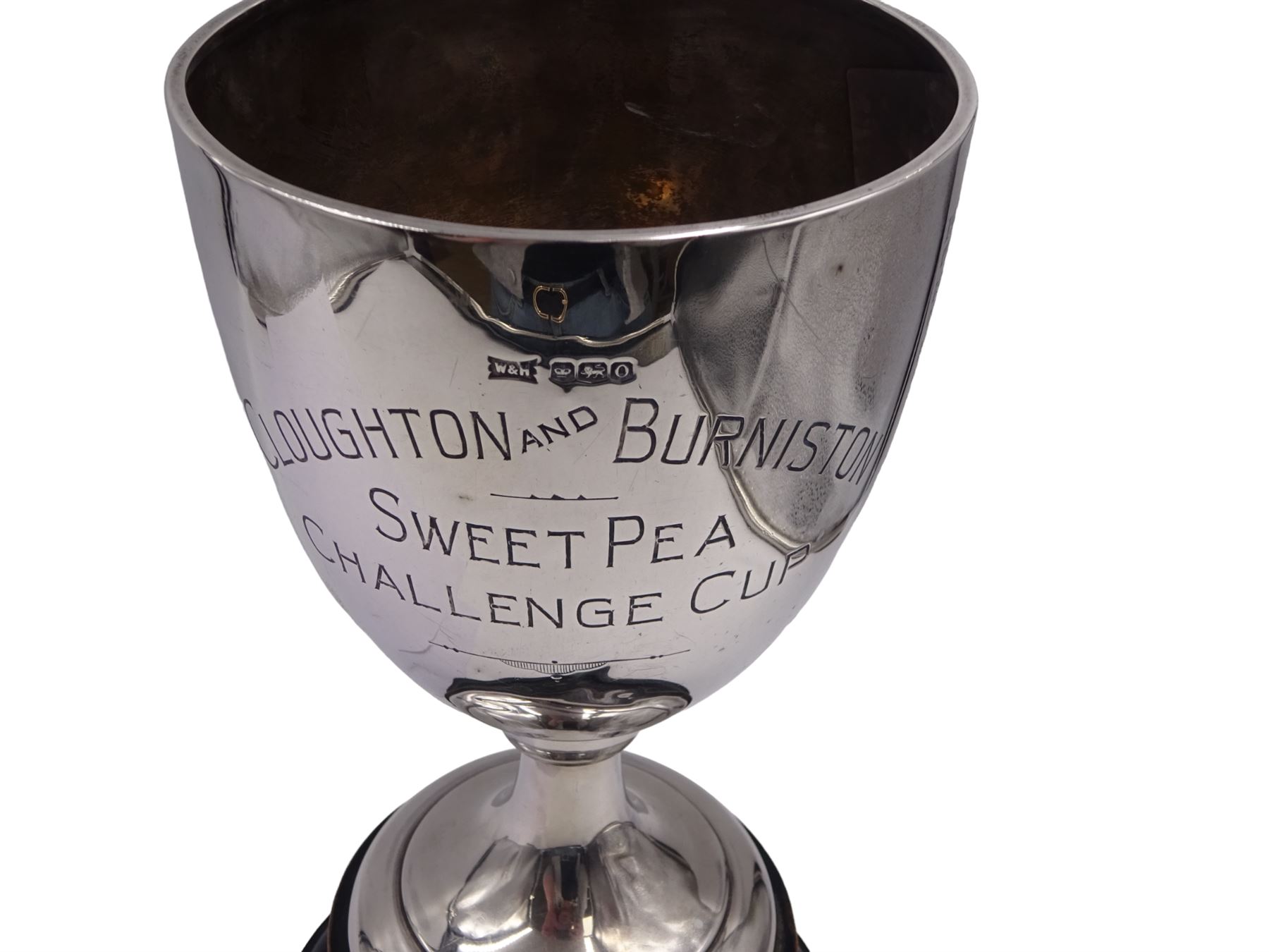1930s silver trophy cup, of plain form, upon knopped stem and circular stepped foot, body with presentation engraving 'Cloughton and Burniston Sweet Pea Challenge Cup' with winners engraved verso, hallmarked Walker & Hall, Sheffield 1931, upon ebonised base, including base H28.7cm
