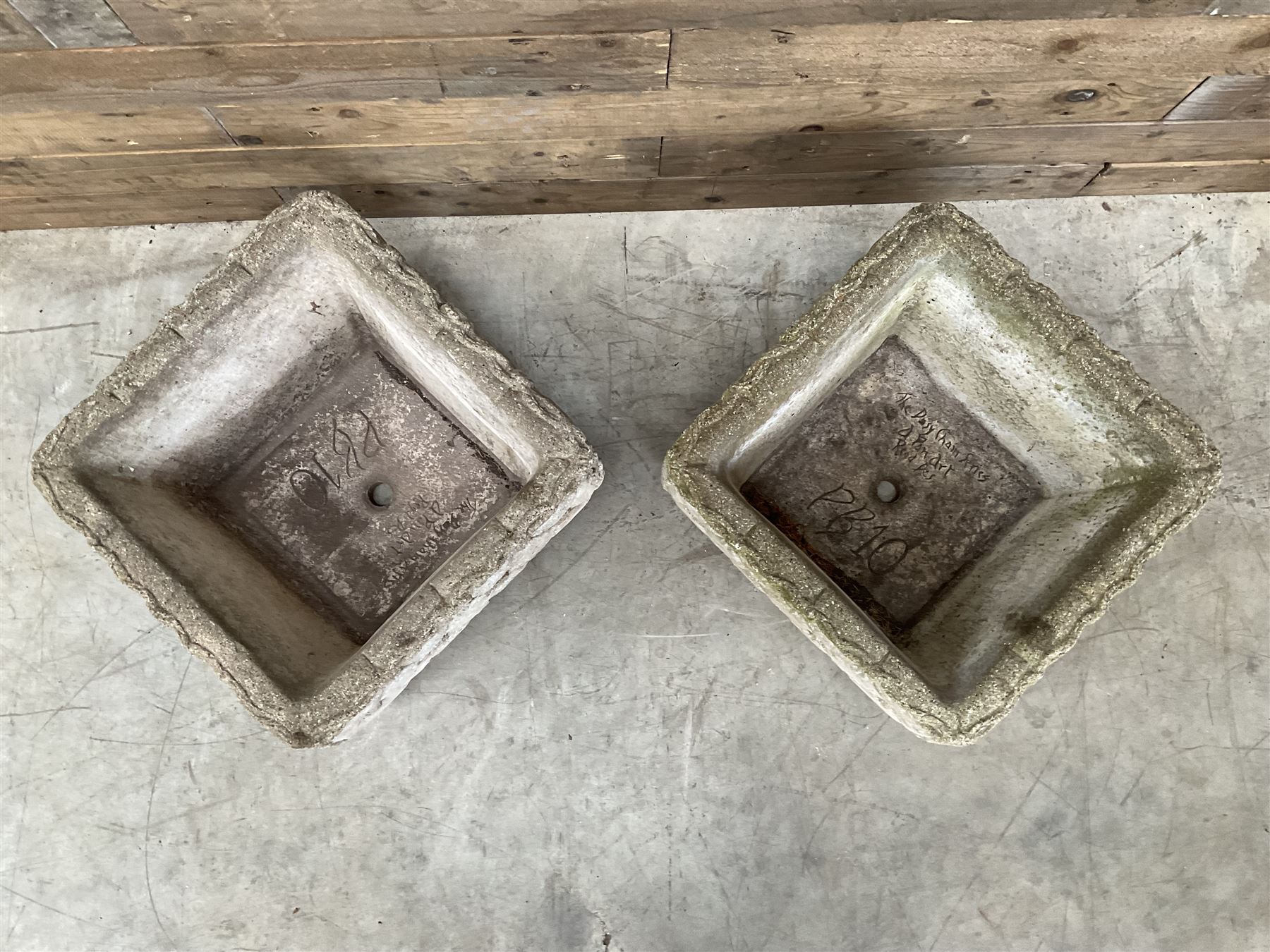 Pair of weathered cast stone square planters, daisy chain detail, one stamped