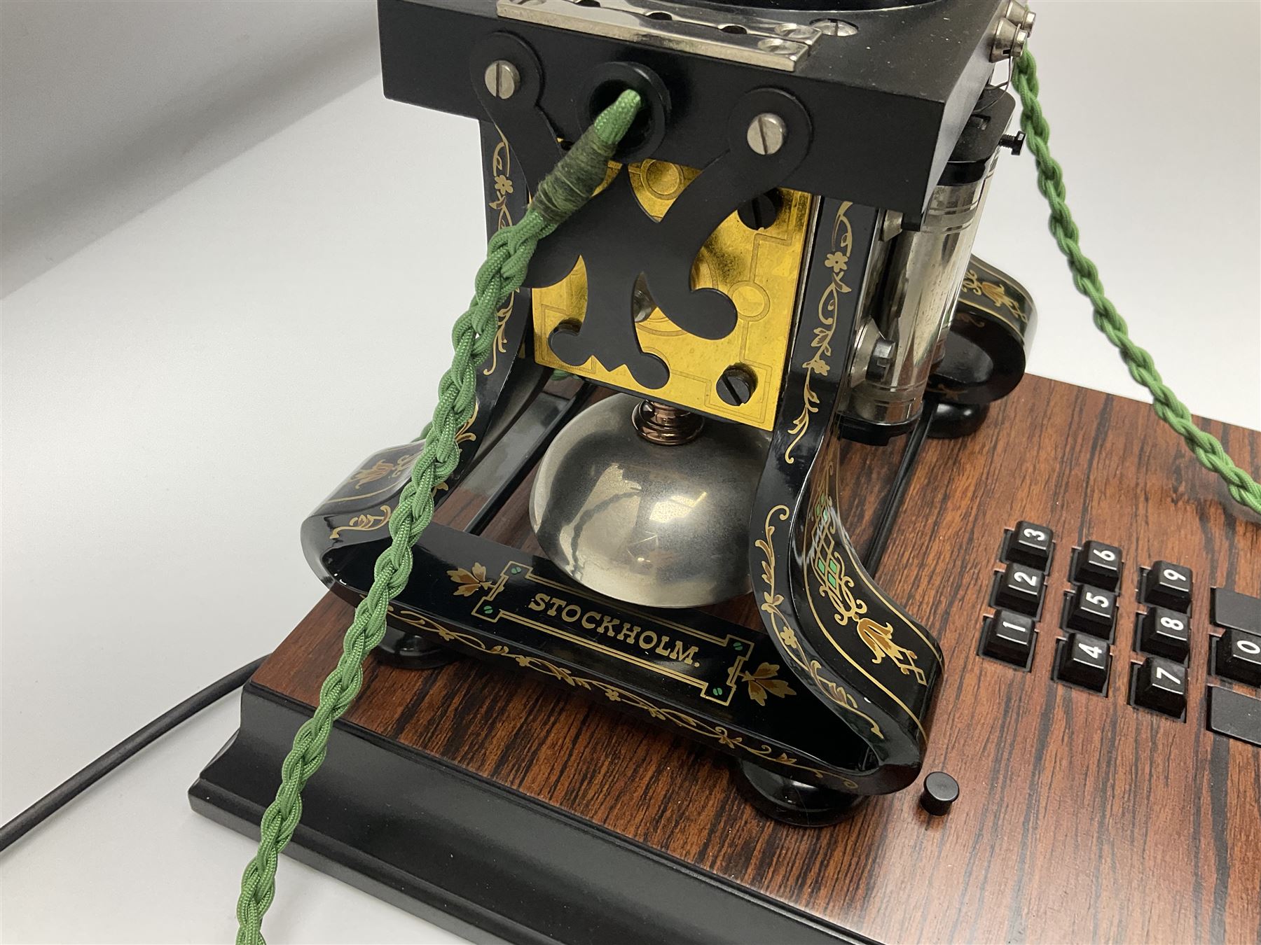 LM Ericsson of Sweden reproduction skeletal telephone, commemorating the centenary of the first 'Tax' in 1892, with gilded details on square walnut base with keypad and brass plaque beneath numbered 1892-09305, H35cm