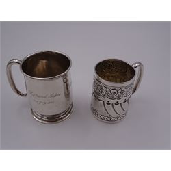 Late Victorian silver christening mug, of tapering cylindrical form with C handle, embossed with part fluting, flower heads and scrolls, hallmarked Atkin Brothers, Sheffield 1898, H7cm, together with a mid 20th century silver christening mug, with C handle and engraved dedication to body, upon a stepped circular foot, hallmarked Joseph Gloster Ltd, Birmingham 1955, H8cm, approximate total weight 5.63 ozt (175 grams), (2)