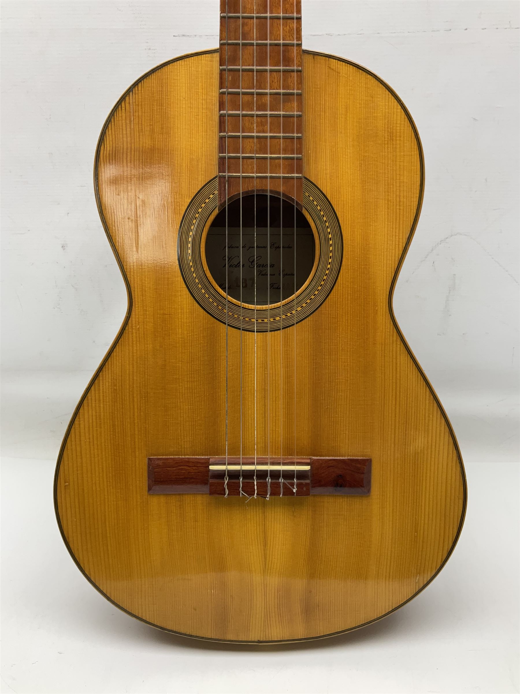 Encore black electric cut-away guitar L96cm; and Spanish Victor Garcia model 187 acoustic guitar, bears label dated 1972 L99cm; each in soft carrying case (2)