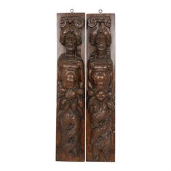 Pair of 17th century carved oak terms, each depicting a male figure in headpiece, with fis...