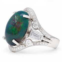 Platinum black opal and diamond ring, four claw set with a single oval cabochon opal of approx 8.45 carat, the openwork surround milgrain set with forty-eight round brilliant cut diamonds and tapered baguette cut shoulders, London 2025