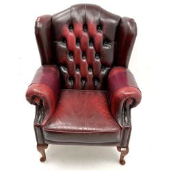Georgian style wing back armchair upholstered in studded deep buttoned oxblood leather, scrolling arms, cabriole feet