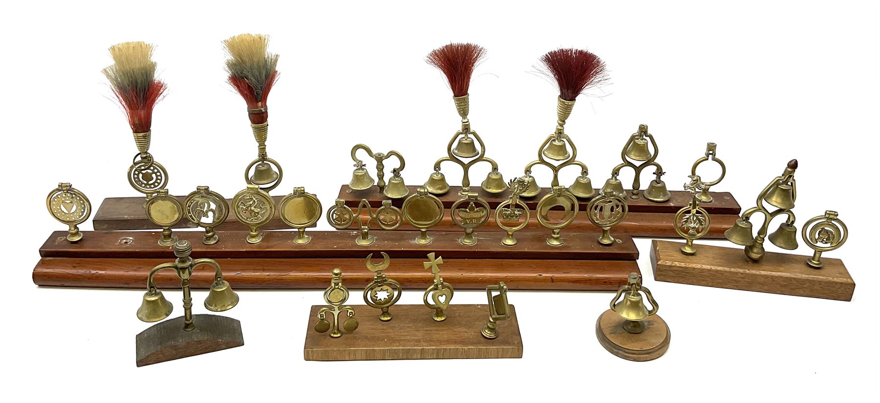 Brass horse terrets, many mounted on wood, including four examples with plumes