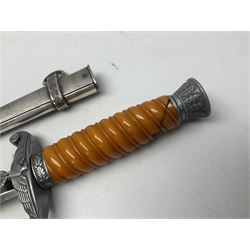 Late WW2 German Army Officers dress dagger, with unmarked 25cm double edged steel blade, orange celluloid grip, pommel and ferrule with oakleaves relief and cross guard with eagle; in original beaded scabbard with two hanging rings L39.5cm overall