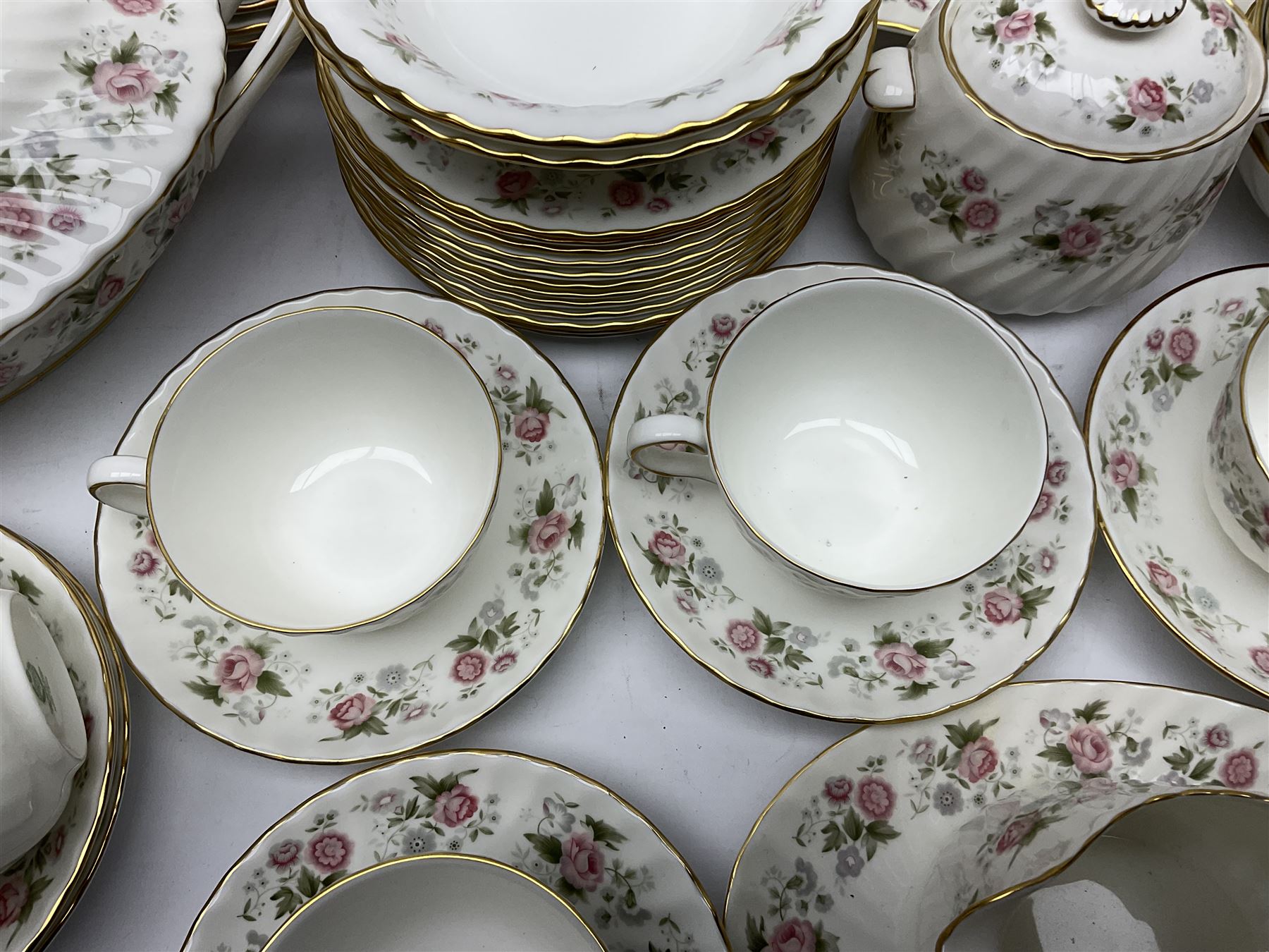 Minton Spring Bouquet pattern dinner and tea service, comprising dinner plates, twin handled tureens with covers, meat platter, teapot, milk jug, sugar bowl with cover, tea cups and saucers, bowls, cake plate, side plates, dessert plates, etc all with printed mark beneath (82)