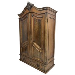 Late 19th century to early 20th century French walnut armoire wardrobe, the shaped pediment carved with shell C-scroll with extending scrolled foliage decoration, enclosed by two doors with shaped and figured panels, fitted with single drawer to base