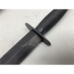 Third Pattern Commando Knife or Dagger with 17.5cm flattened diamond section blade and regulation black painted ribbed copper hilt with brass pommel nut; stamped William Rodgers Sheffield England to the cross-piece; in black painted brass mounted leather scabbard L34.5cm overall