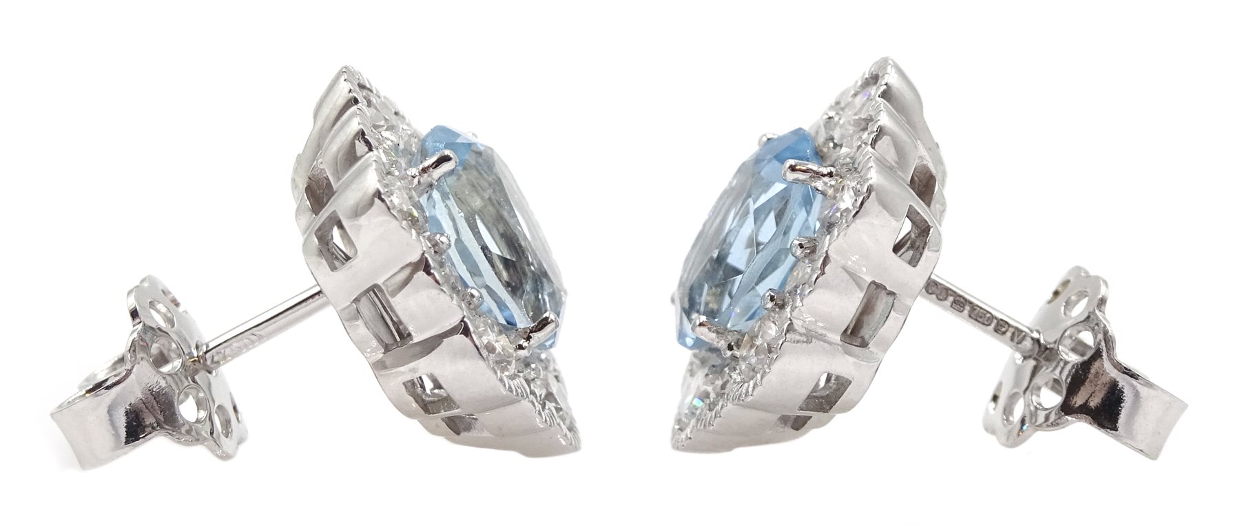 Pair of 18ct white gold oval aquamarine and diamond cluster stud earrings, hallmarked, total aquamarine weight approx 2.50 carat, total diamond weight approx 0.75 carat