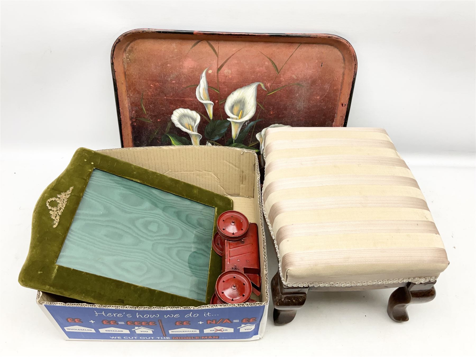 Early 20th century metal tray painted with calla lilies on red ground, together with footstool, green velvet photograph frame and Triang tractor No. 2