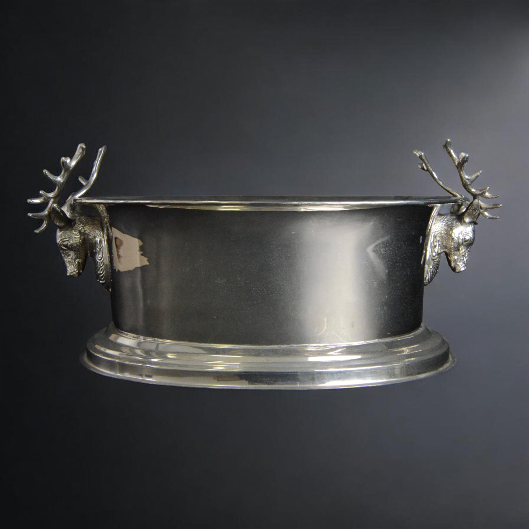 Large oval silver plated champagne cooler, with stag handled, upon a stepped base, H16cm, L38cm
