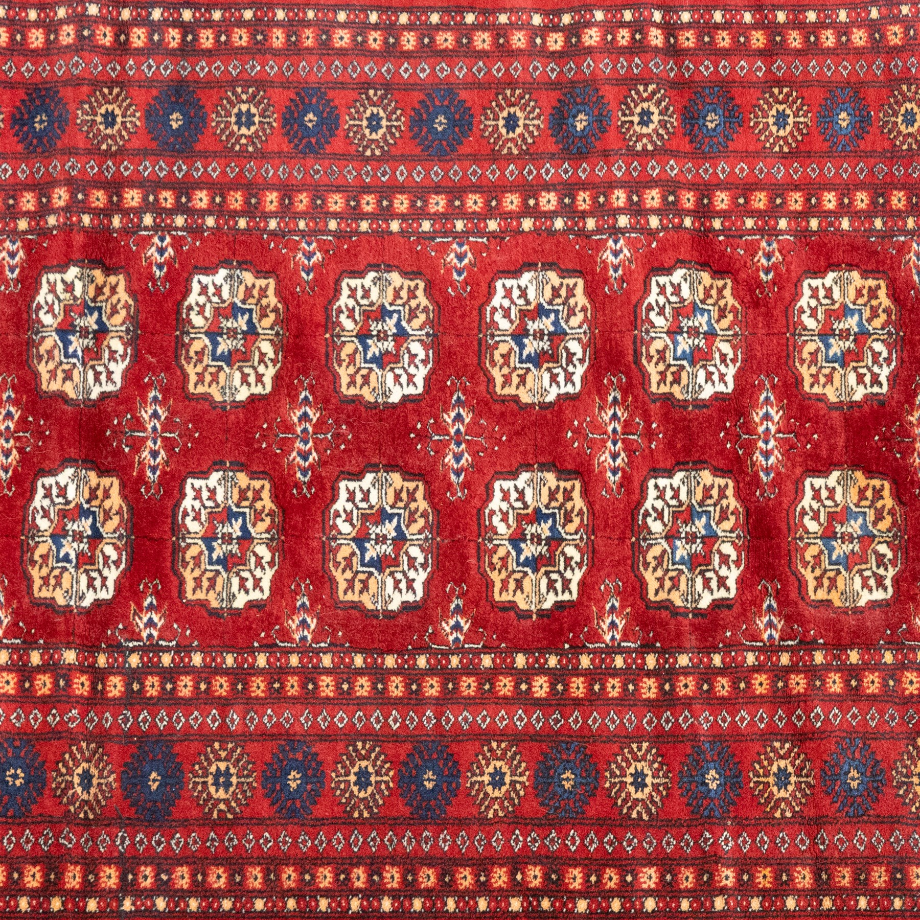 Two hand-knotted rugs, comprising Persian floral rug, dark blue ground decorated with scrolling foliage and flowerheads within a red floral border (H 208cm, W 134cm); Bokhara type rug, red ground with repeating gul motifs and geometric guard borders (H 174cm, W 94cm)