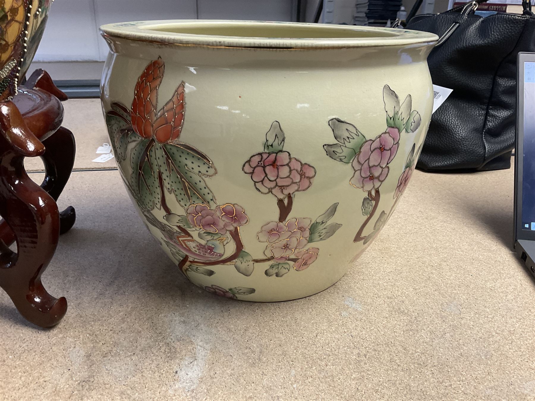 20th century Oriental fish bowl jardinière, decorated with reserves of birds amongst flowers, on wooden stand, fish bowl H29cm D36.5cm, together with another smaller example 