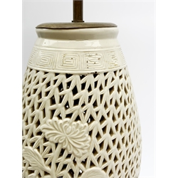 A Chinese reticulated or pierced white glazed lamp base, on wooden stand, overall H52.5cm. 