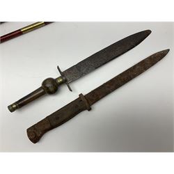 19th century continental folding knife with 15.5cm single edged blade, the pierced brass and iron handle with remains of horn grips L21.5cm overall closed; turned horn handled knife with foliate engraved blade; battlefield relic German 1884/98 knife bayonet; iron spear head; leather covered swagger stick; and two-piece gun cleaning rod