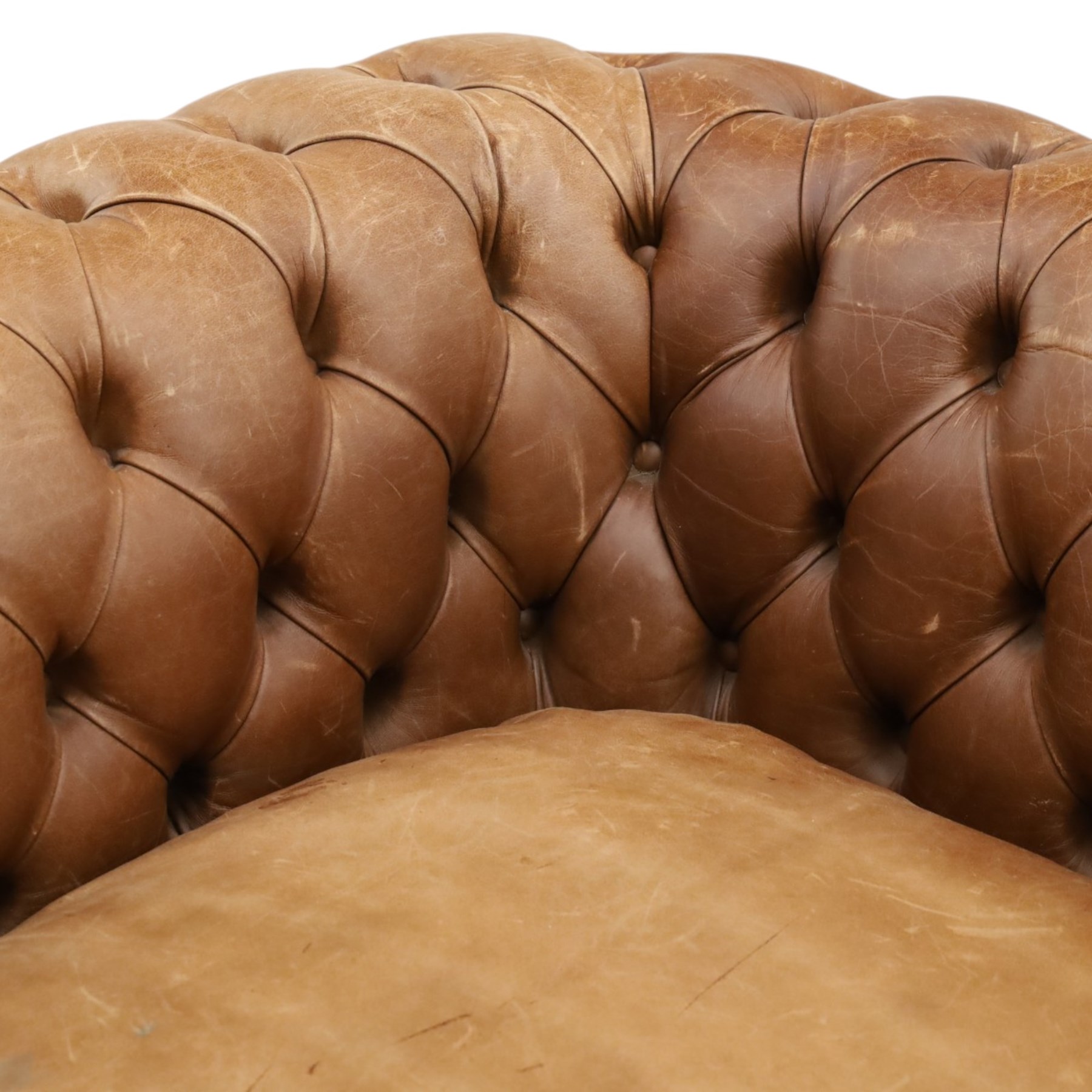 Fleming & Howland Ltd - large traditional shape four seater chesterfield club sofa, the rolled ack and arms with studwork, upholstered in buttoned tan leather with loose seat cushions, raised on large turned feet