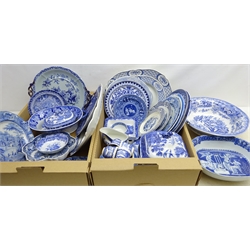  Early 19th century and later English transfer printed tableware including Willow pattern, Spode plates, Ironstone two handled stand, meat plate, Wedgwood serving bowl and other blue and white in two boxes  