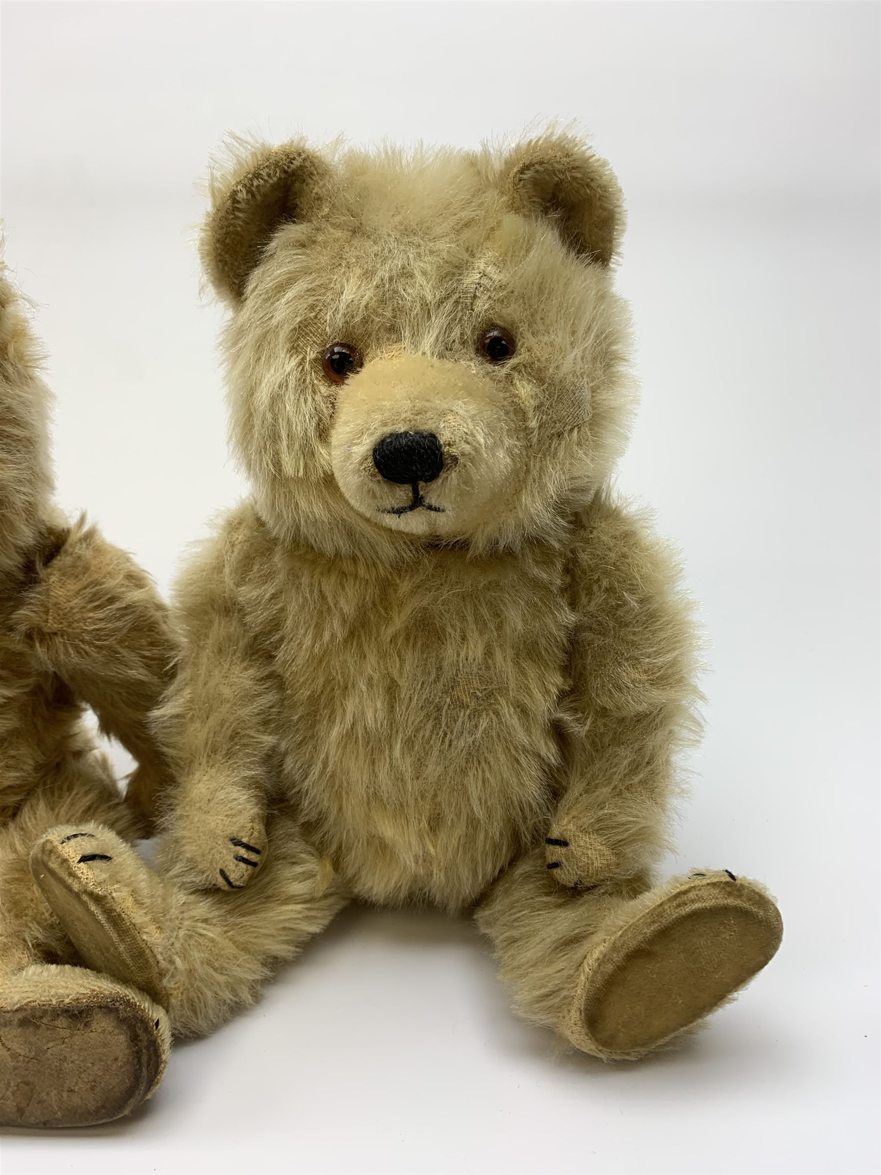Chiltern Ting-a-Ling teddy bear c1950s with blond mohair body, swivel jointed head with glass eyes and vertically stitched nose and mouth, jointed limbs with velvet pads and card lined feet and internal chimes H14