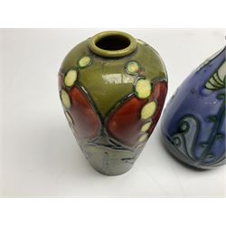 Minton Secessionist vase, with tube-lined stylised flower head decoration on a blue ground, printed mark to base 'Minton Ltd, No. 30', together with another Minton Secessionist tubelined vase,  printed mark to base 'Minton Ltd, No. 16', tallest example H13.5cm