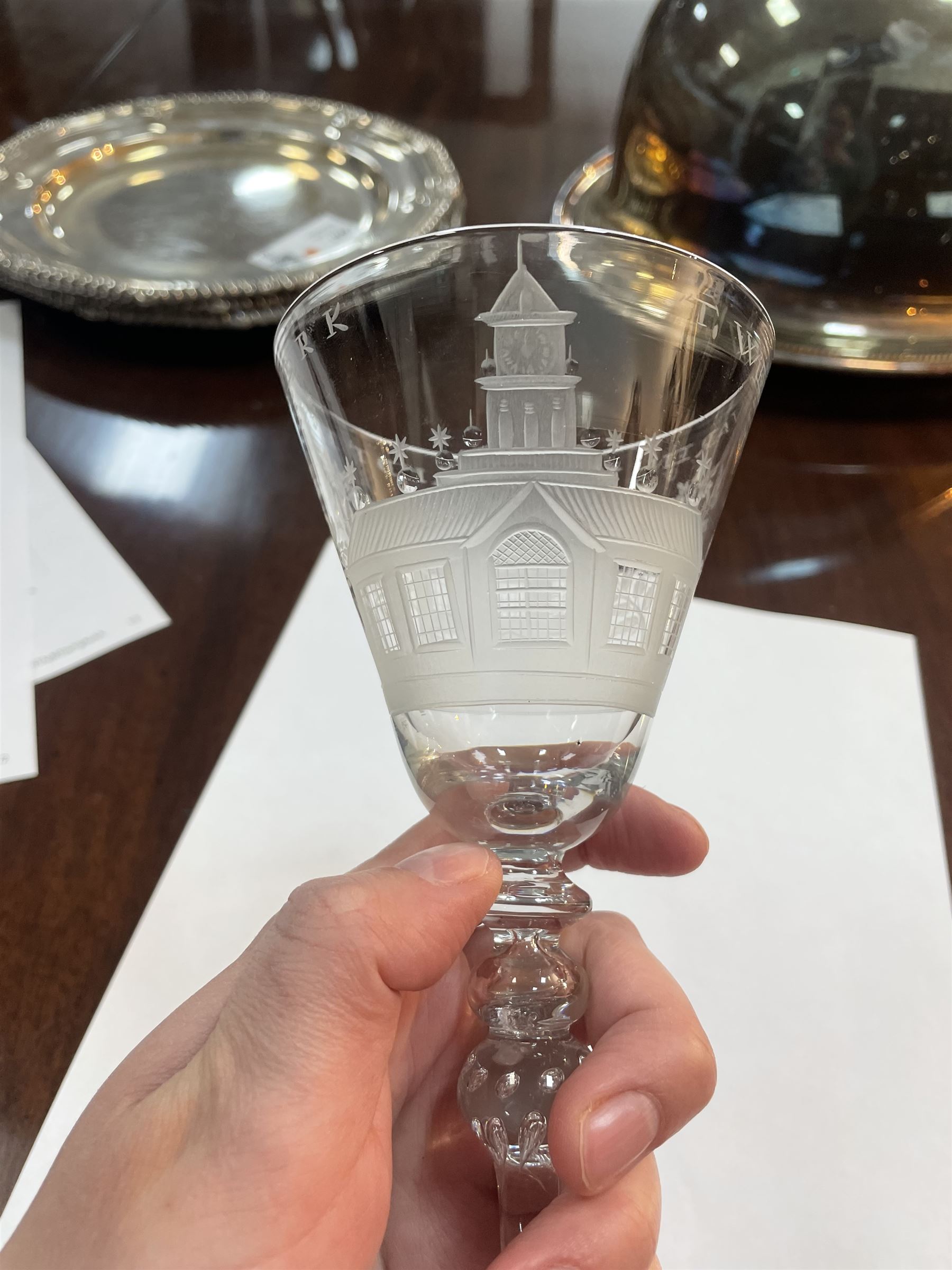 Dutch engraved Newcastle light baluster glass, circa 1760, the funnel bowl engraved with a two storey country house and church flanked by trees, beneath the inscription ‘T WELVAREN VAN LANDT ENKERK’ (The prosperity of the Country and Church), upon a multi knopped stem with beaded knop and basal knop, over conical foot, H18cm



