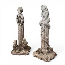 Pair of weathered composite stone garden figures, modelled as a girl and a young satyr playing the panpipes seated on column supports, the fluted columns with climbing ivy vines and surmounted animal, butterfly and other zoomorphic motifs