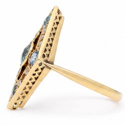 Early 20th century gold blue stone and split pearl diamond shaped ring, five milgrain set round cut stones possibly zircon or aquamarines, with seed pearl surround in a pierced design setting, stamped 18ct 