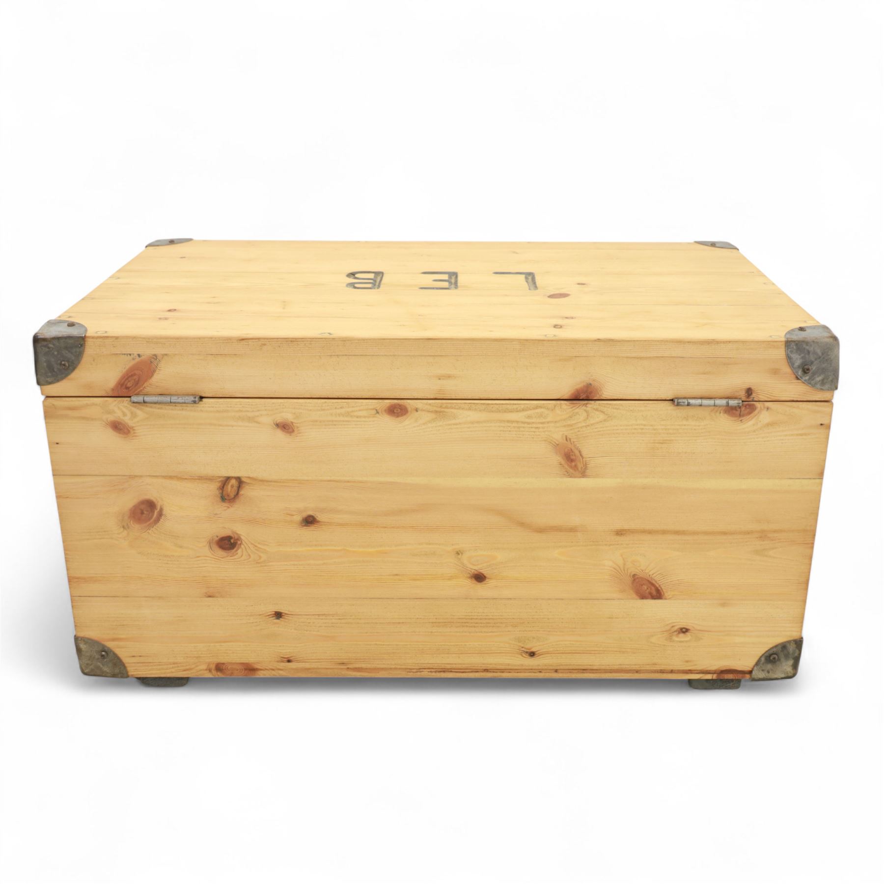 Pine storage trunk, of rectangular plank construction with metal corner protectors and stencilled lettering ‘LEB’ to front and lid