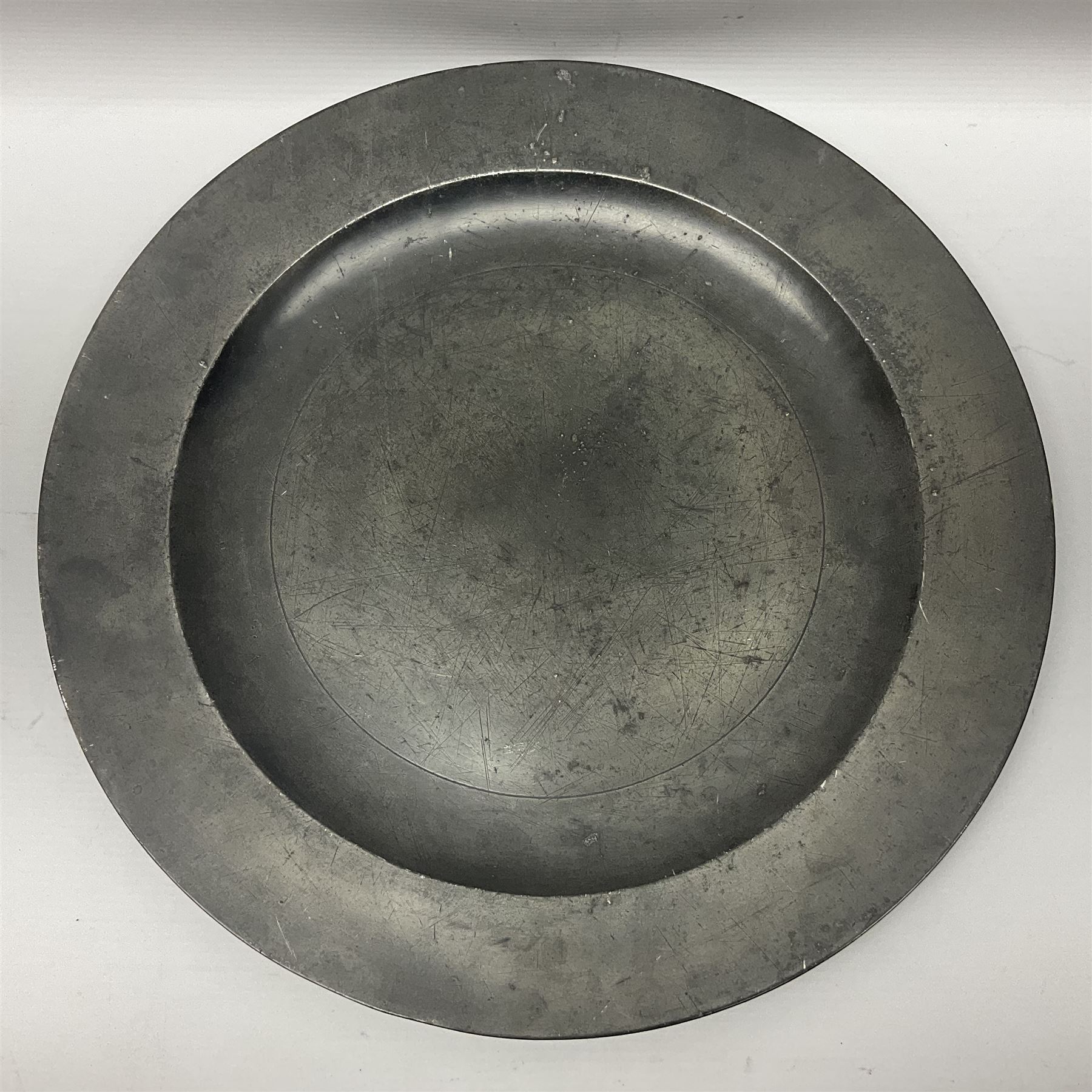 Group of seven 19th century pewter chargers, each of circular form with dished centre, two examples with touch marks verso, each approximately D39cm