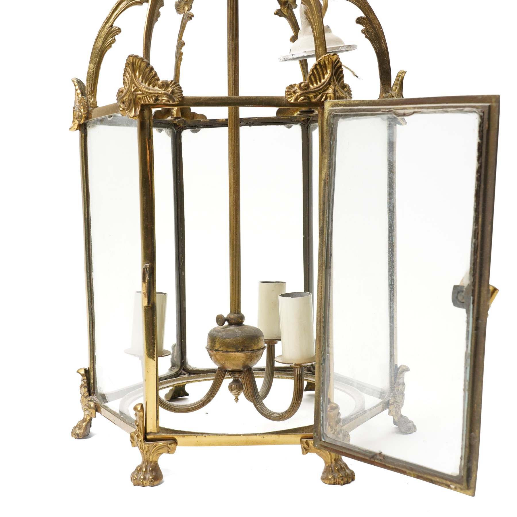 Three light hall lantern in metal and glass case, of hexagonal form, with classical decoration including a hand holding scroll handle, drop 72cm