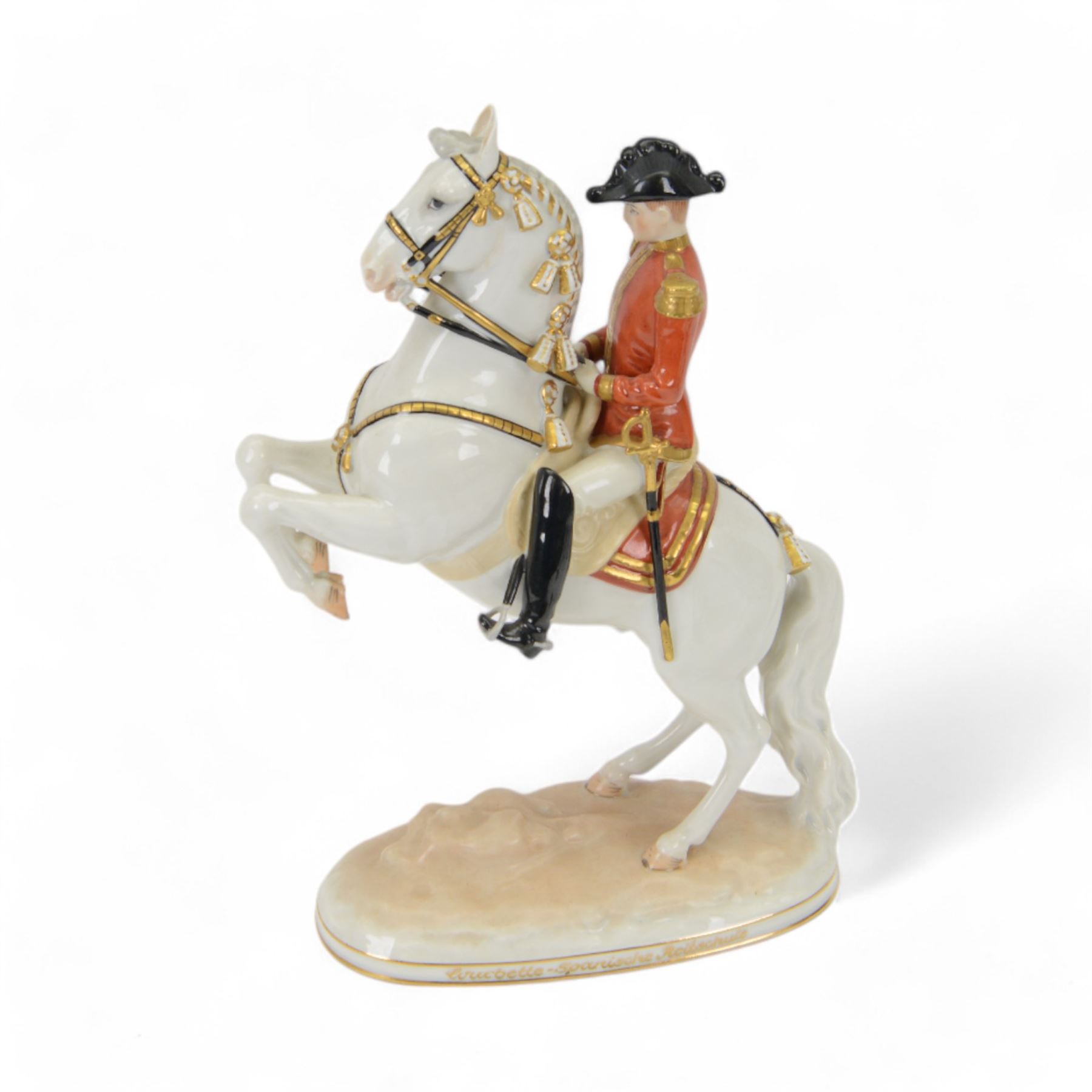 Royal Vienna Augarten figurine, modelled a Spanish Riding School rider upon rearing horse, with Trab-Spanische Reitschule Hofburg Wien in gilt to the base, H30cm