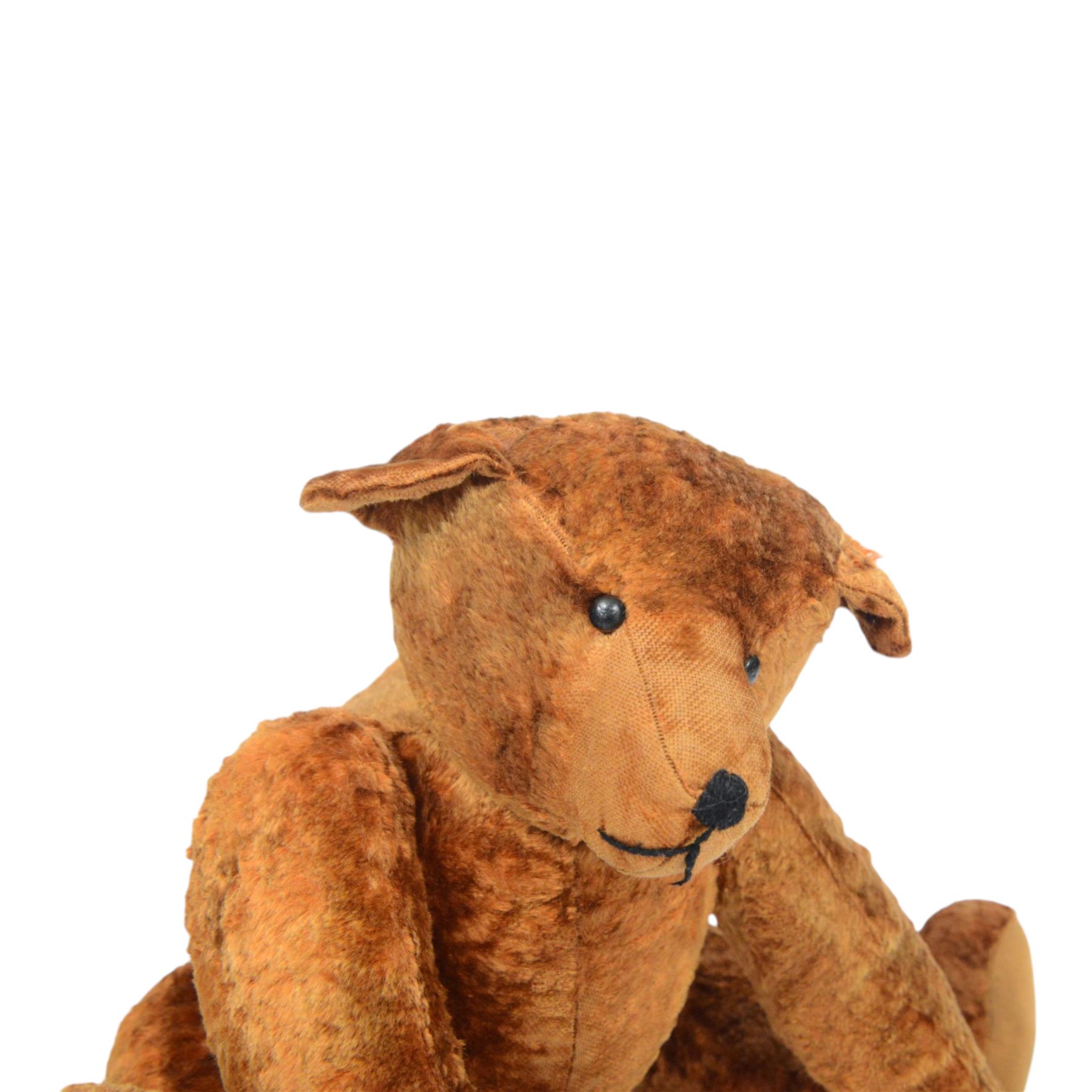 20th century teddy bear, red/brown mohair bear with black plastic eyes, straw filled snout with stitched nose and downturned mount, jointed limbs, swivel head and hump to back, H52cm
