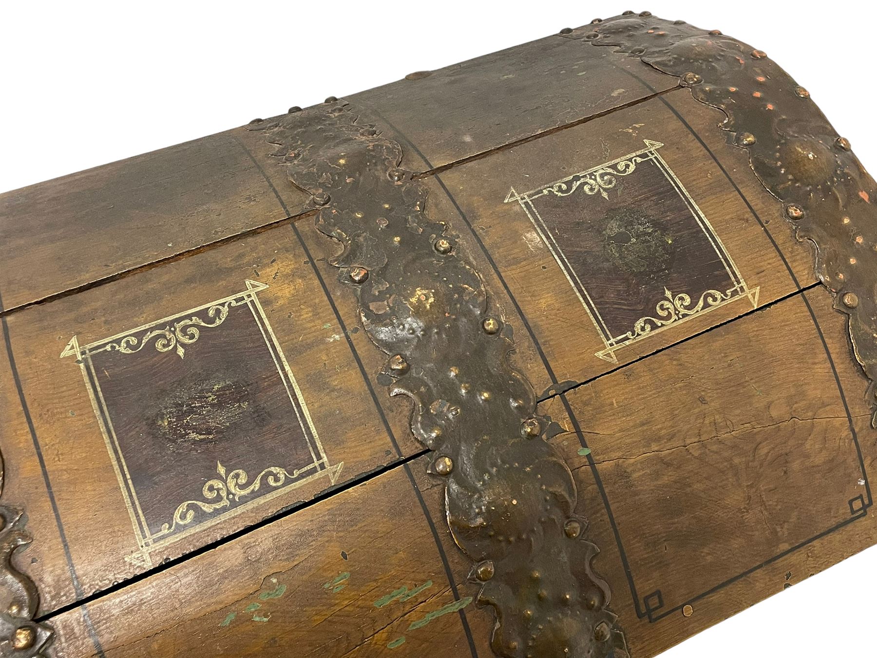 19th century painted oak sea chest, hinged dome top enclosing small compartment, bound by shaped and pressed metal strapwork, scumbled finish to resemble oak and painted with small vignettes depicting portraits and landscapes within panels, fitted with large wrought metal carrying handles, the front inscribed 'H.J.S. 1870' 
