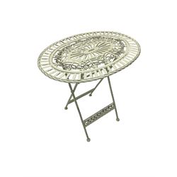 Washed white finish metal garden folding table, strap seat, pierced oval top with foliate decoration, raised on rope twist supports united by fretwork stretcher