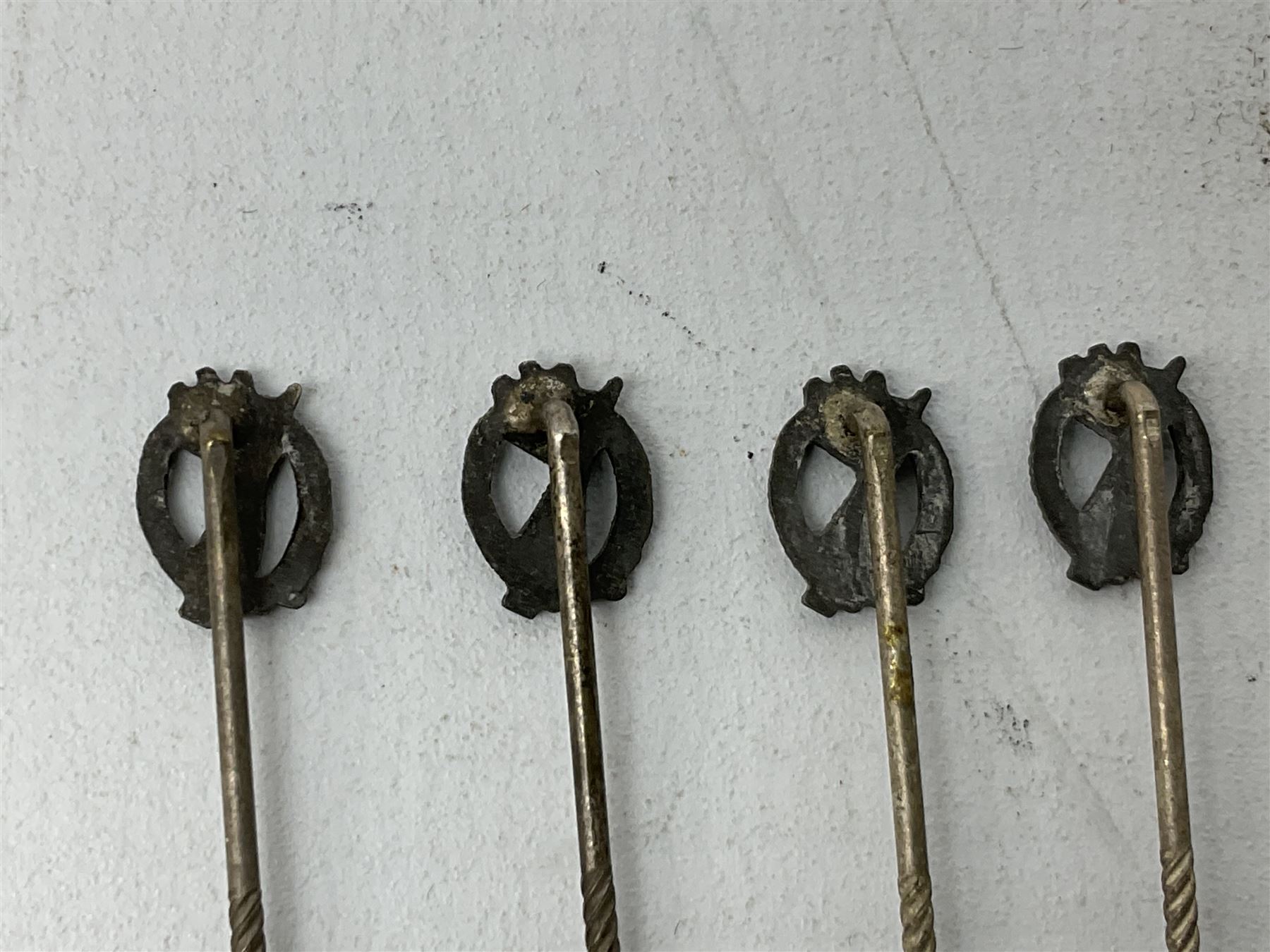 Nine WW2 German lapel pins including five Infantry Assault, Tank